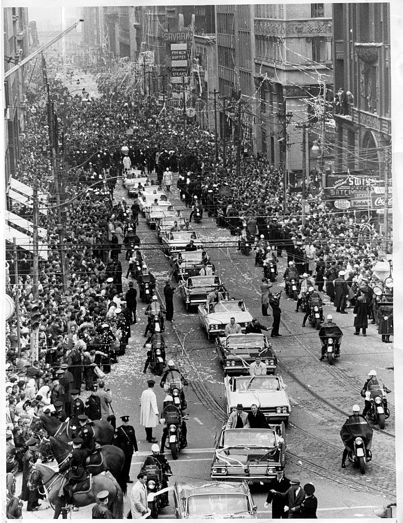 The 1963 Stanley Cup parade on Bay Street in Toronto, viewed above a crowd and motorcade.